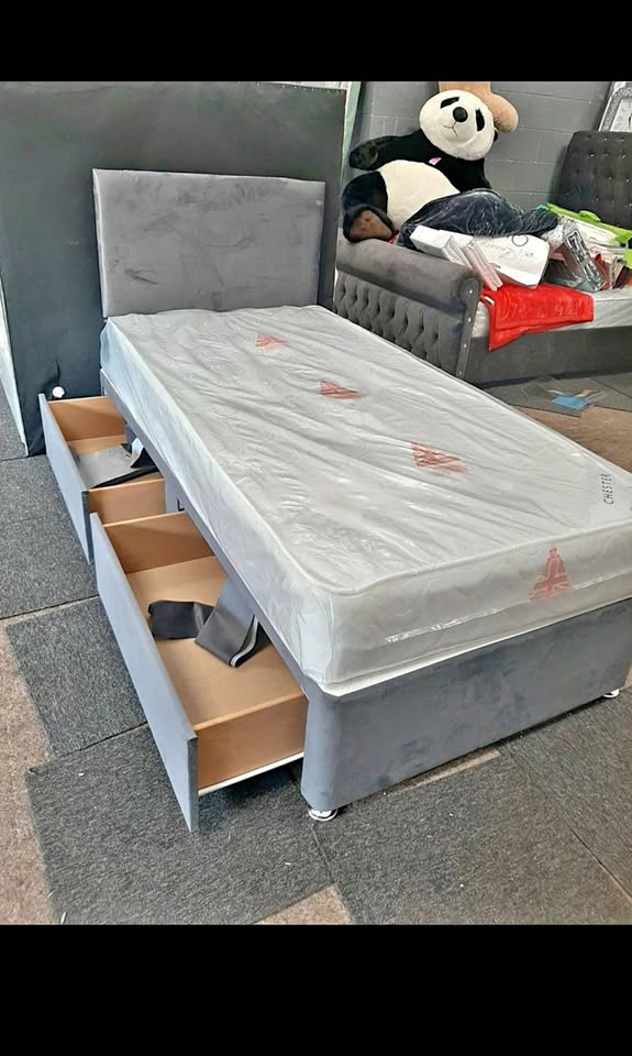 Grey divan with open drawers